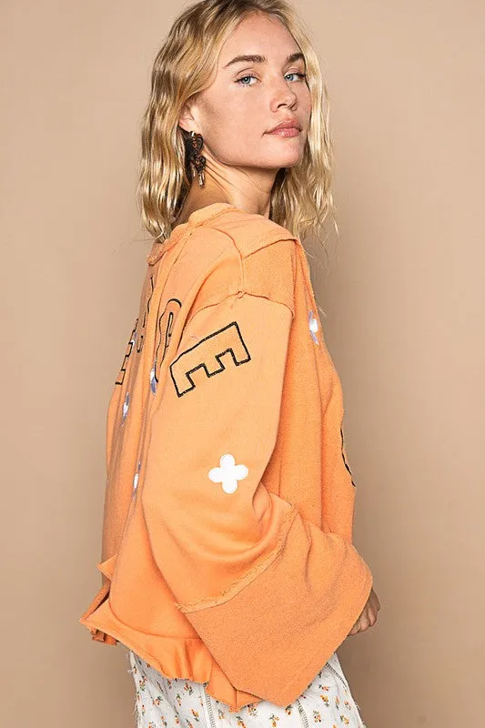 Orange Peace Embroidered Exposed Seam Back Ruffle V-Neck Top